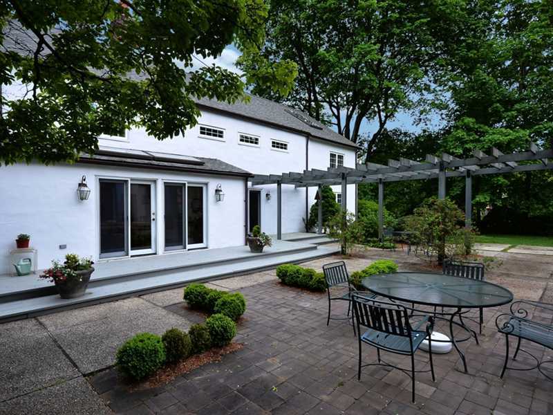 331 Hollow Tree Ridge Road Darien, CT 06820 - Photo 14 of 19 a view of a house with backyard sitting area and swimming pool