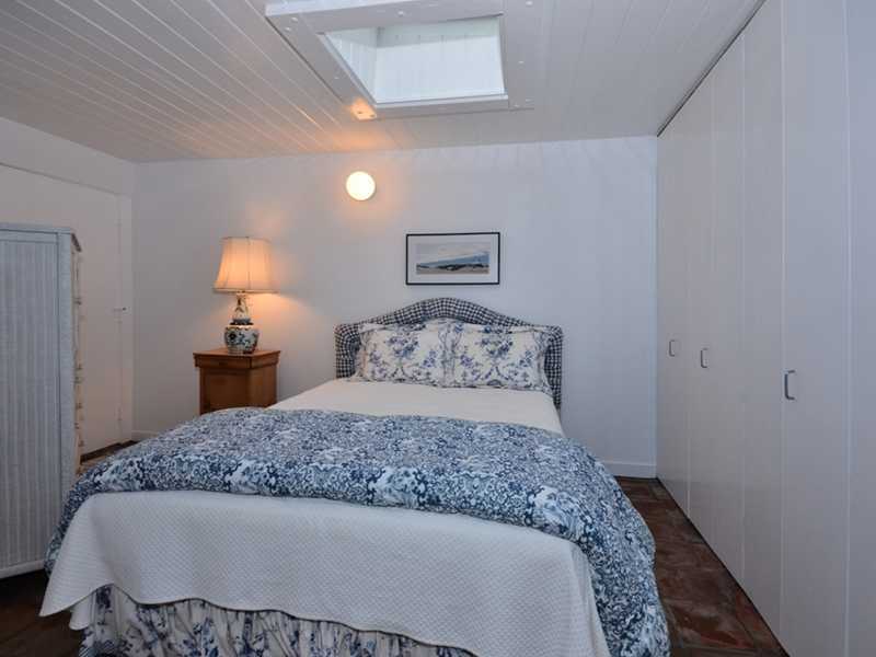 331 Hollow Tree Ridge Road Darien, CT 06820 - Photo 19 of 19 a bedroom with a bed and a lamp