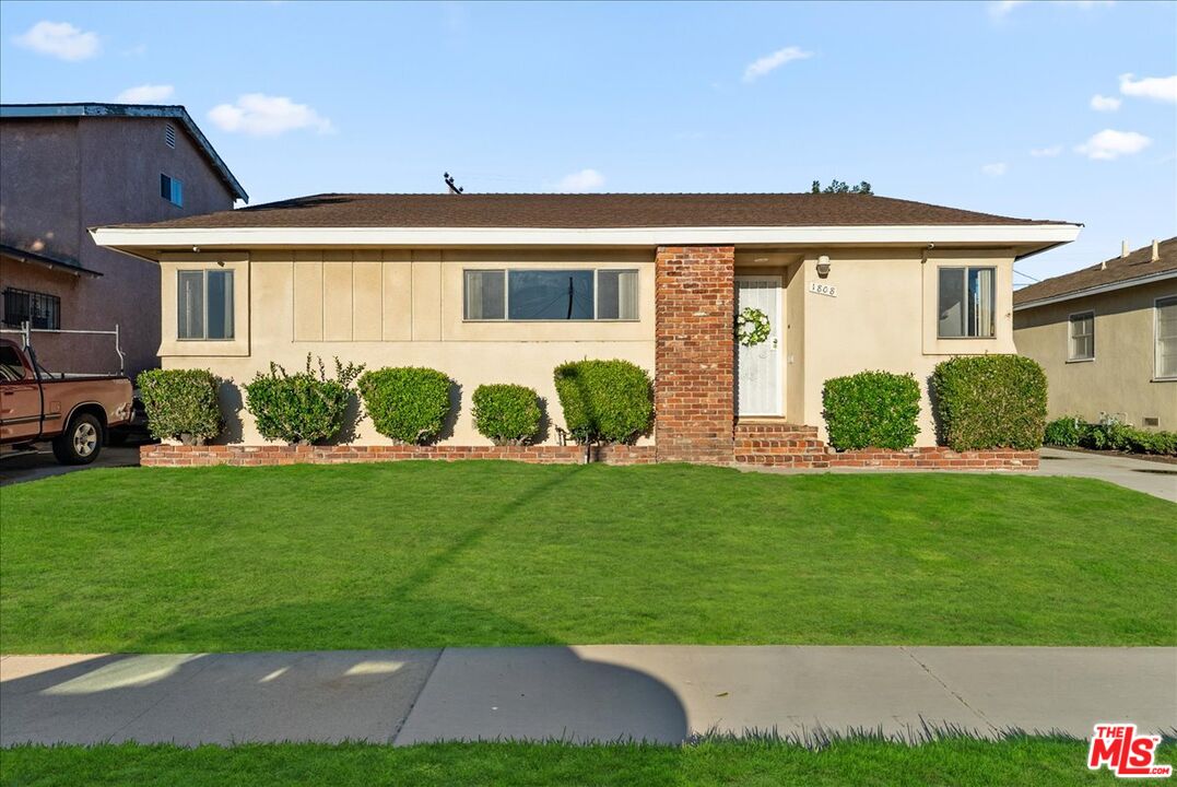 1808 North Elva Avenue Compton, CA 90222 - Photo 1 of 2 a front view of a house with garden