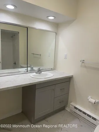 a bathroom with a sink a mirror and a toilet