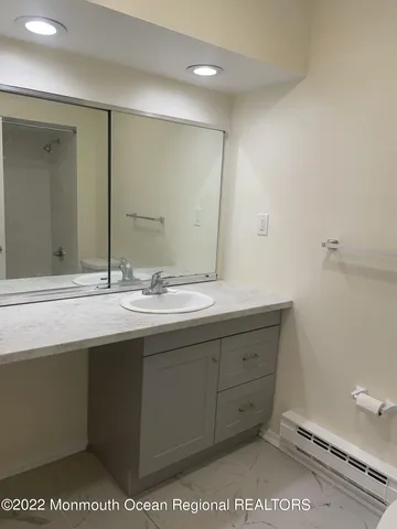 a bathroom with a sink a mirror and a toilet