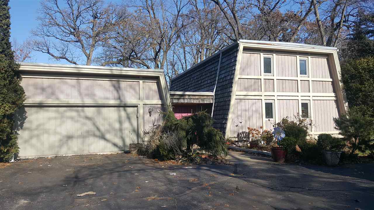 4802 Spring Creek Road Rockford, IL 61114 - Photo 1 of 25 a view of a house with a yard and potted plants