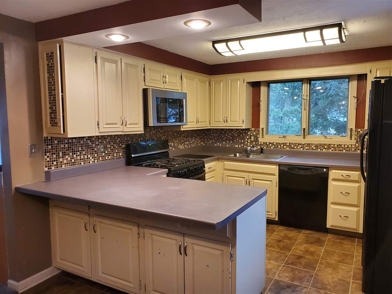 4802 Spring Creek Road Rockford, IL 61114 - Photo 5 of 25 a kitchen with a sink stove and cabinets