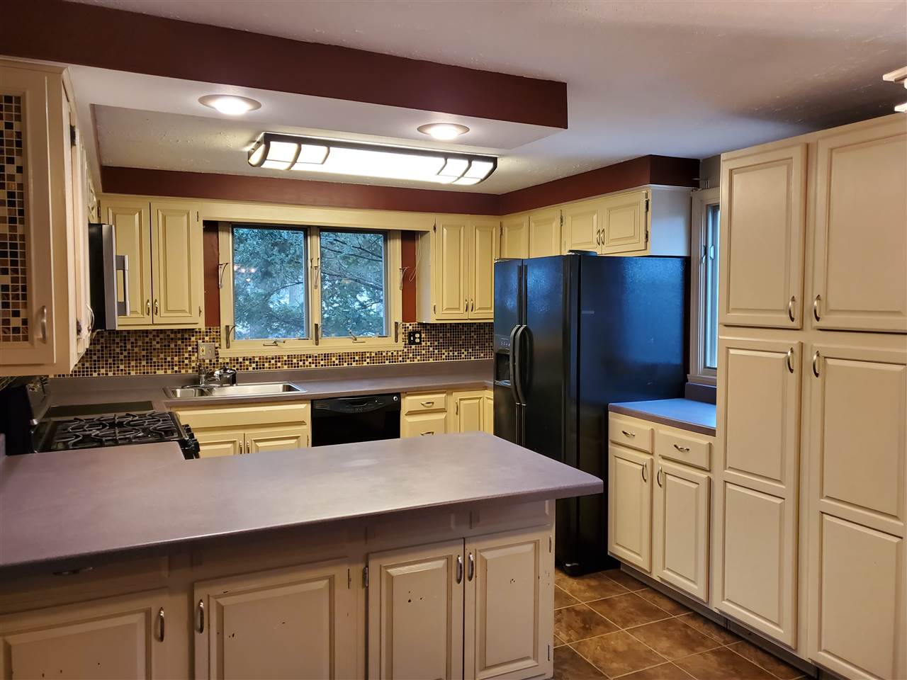 4802 Spring Creek Road Rockford, IL 61114 - Photo 6 of 25 a kitchen with stainless steel appliances a sink and a refrigerator