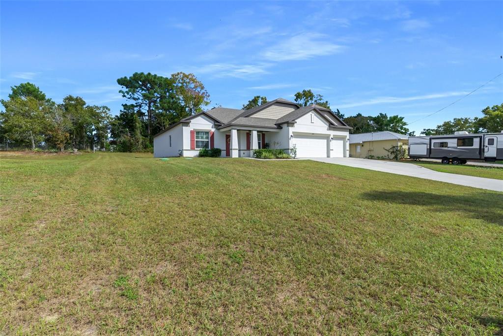 6283 Grapewood Road Spring Hill, FL 34609 - Photo 5 of 41 a front view of a house with a yard