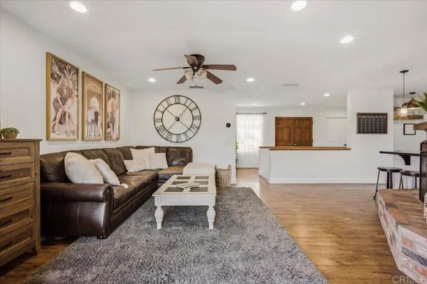 a kitchen with stainless steel appliances granite countertop a stove top oven a refrigerator and a sink