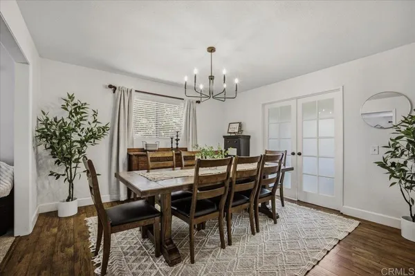 a living room with furniture a flat screen tv and a table