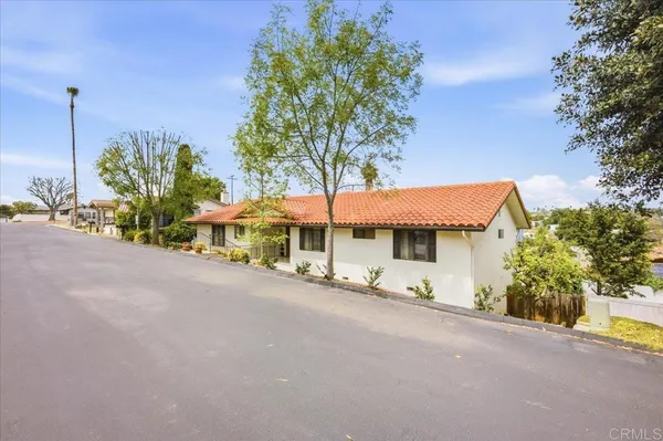 a view of a house with a yard and sitting area