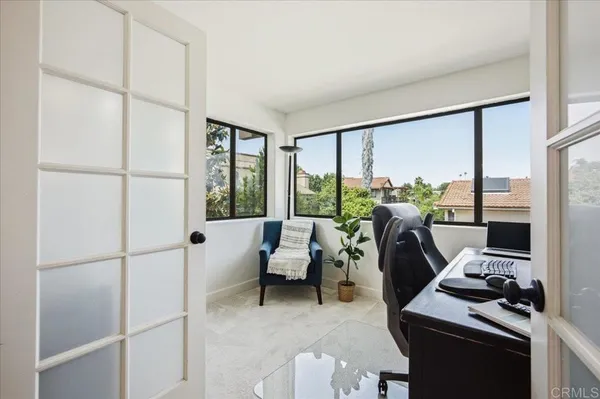 a living room with furniture a rug and a flat screen tv