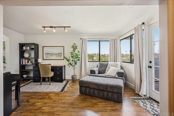 a bedroom with a bed and a potted plant
