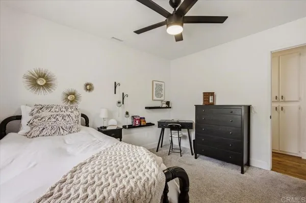 a bedroom with a large bed and a dresser