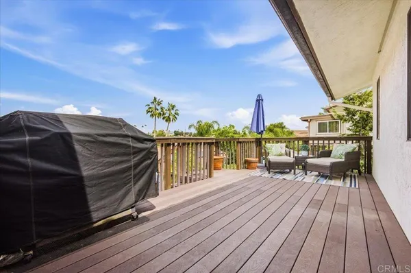 a view of a patio with table and chairs with wooden fence and plants