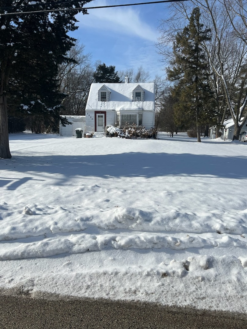 a view of house with snow on the road