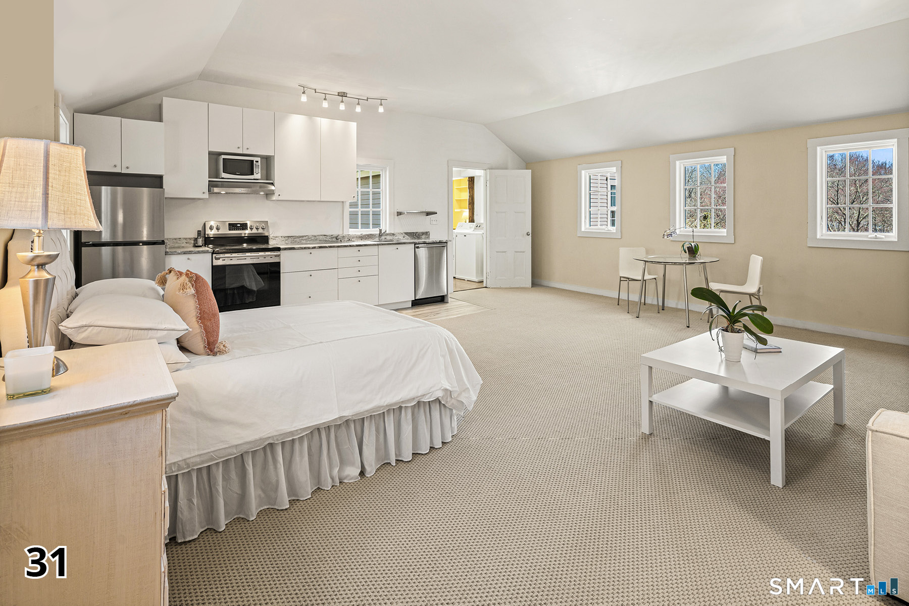 32 Steep Hill Road Weston, CT 06883 - Photo 25 of 41 a bedroom with a bed a table and chair