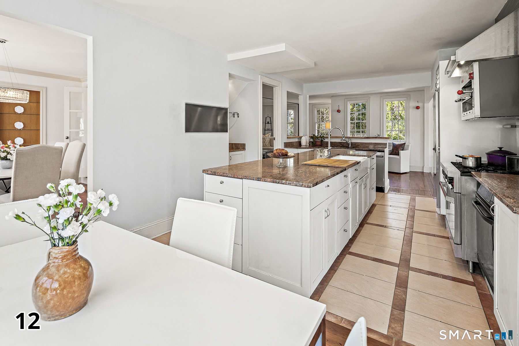 32 Steep Hill Road Weston, CT 06883 - Photo 9 of 41 a large white kitchen with a stove a sink a couch and a dining table
