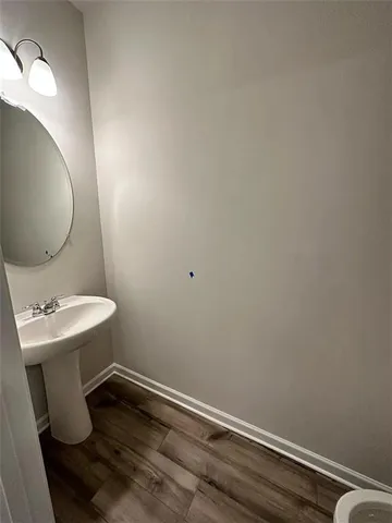 a bathroom with a sink toilet and mirror