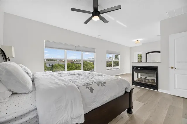 a house with wooden floor outdoor seating and yard in the back