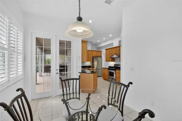 a kitchen with stainless steel appliances granite countertop a refrigerator stove and sink