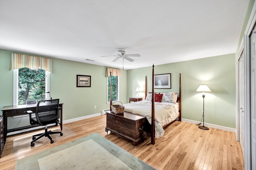 19 Babbling Brook Road Barnstable, MA 02632 - Photo 23 of 35 a spacious bedroom with a bed a table chair and a window