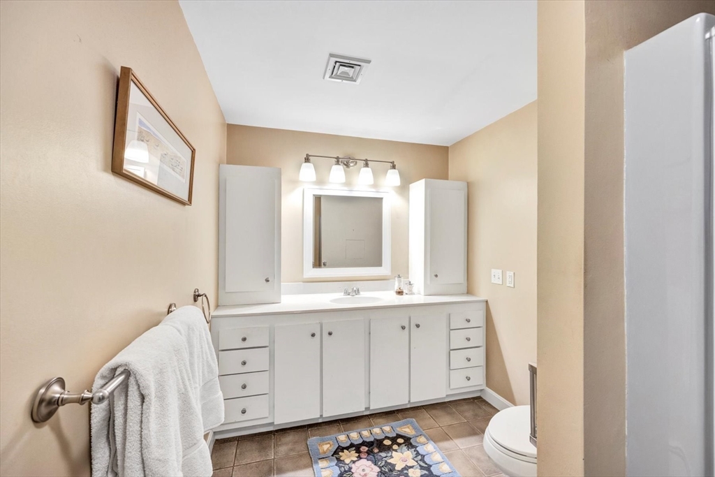 19 Babbling Brook Road Barnstable, MA 02632 - Photo 24 of 35 a bathroom with a double vanity sink and mirror with toilet