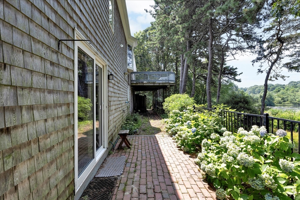 19 Babbling Brook Road Barnstable, MA 02632 - Photo 32 of 35 a backyard of a house with lots of green space