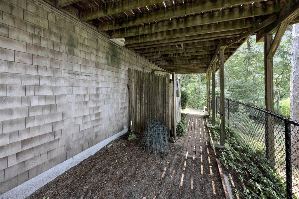 19 Babbling Brook Road Barnstable, MA 02632 - Photo 33 of 35 a backyard of a house with table and chairs
