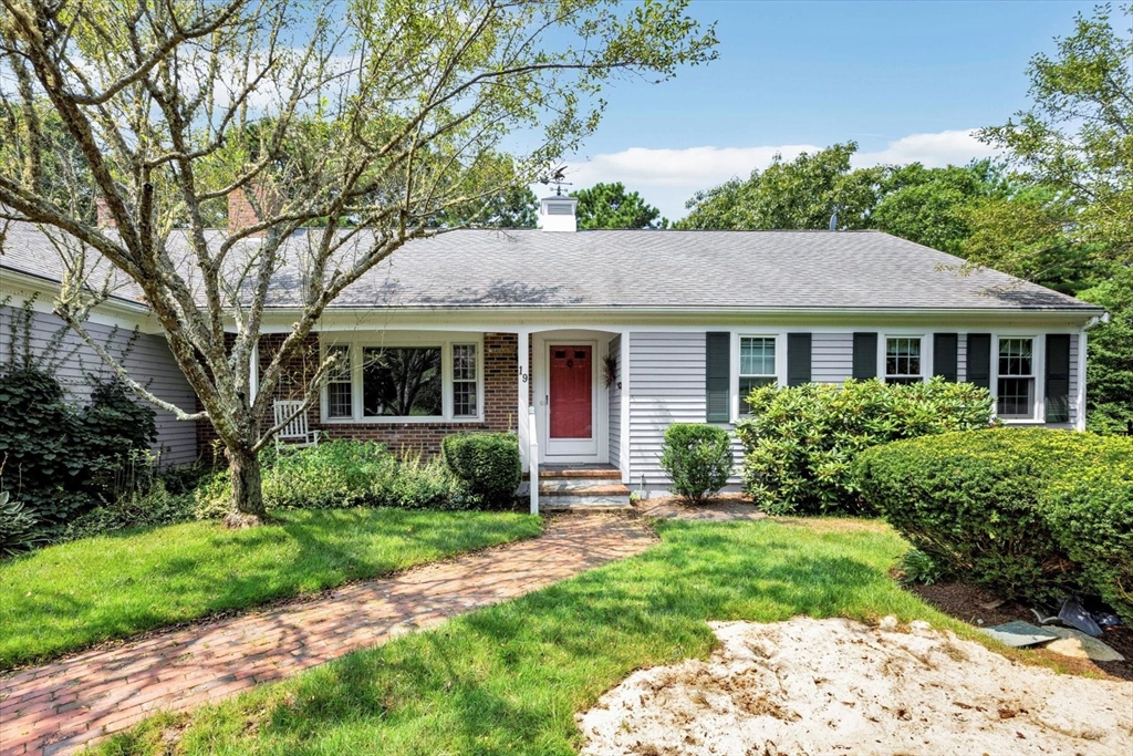19 Babbling Brook Road Barnstable, MA 02632 - Photo 35 of 35 a front view of a house with a yard table and chairs