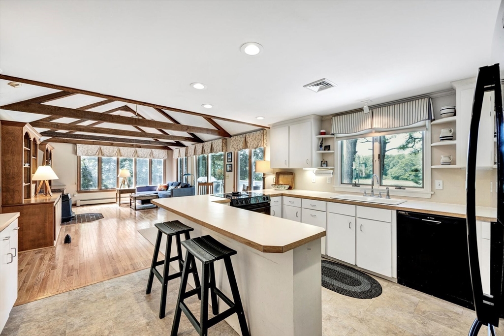19 Babbling Brook Road Barnstable, MA 02632 - Photo 10 of 35 a kitchen with a table chairs stove and cabinets