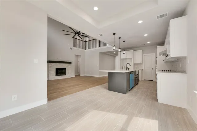 a kitchen with kitchen island a counter top a stove a sink and a refrigerator
