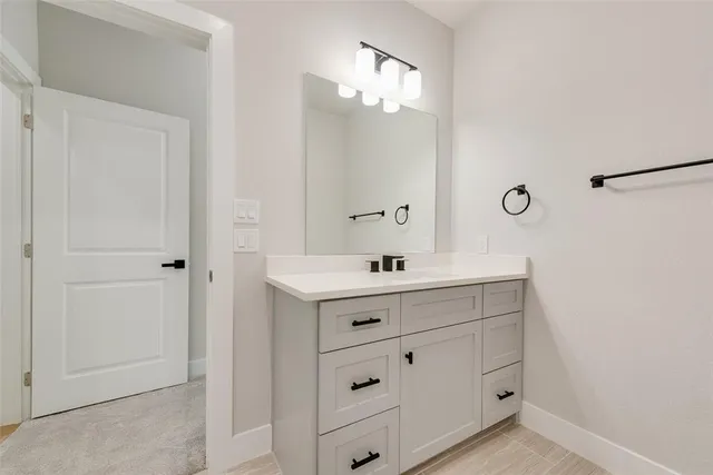 a bathroom with a double vanity sink a mirror and shower