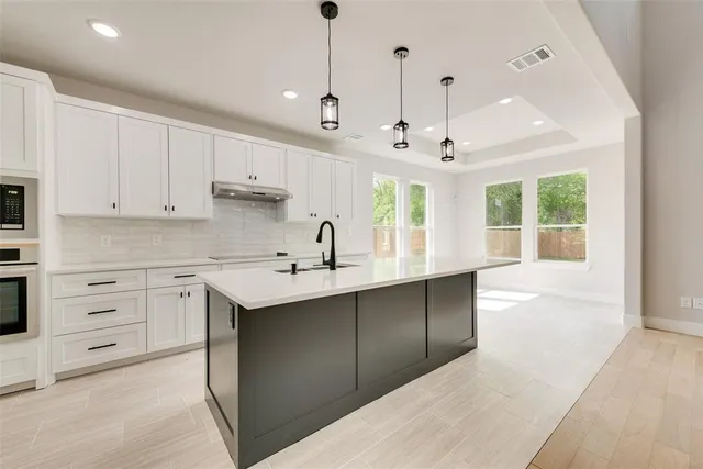 a kitchen with a sink window and cabinets
