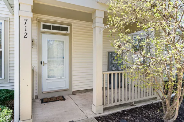 a view of a porch with a door and wooden fence