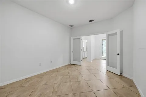 a bedroom with a bed couch and a window