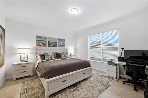 a bedroom with a bed and a large mirror