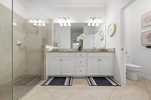 a living room with furniture a rug and a book shelf