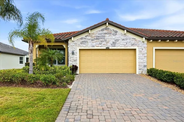 a front view of a house with a yard and garage