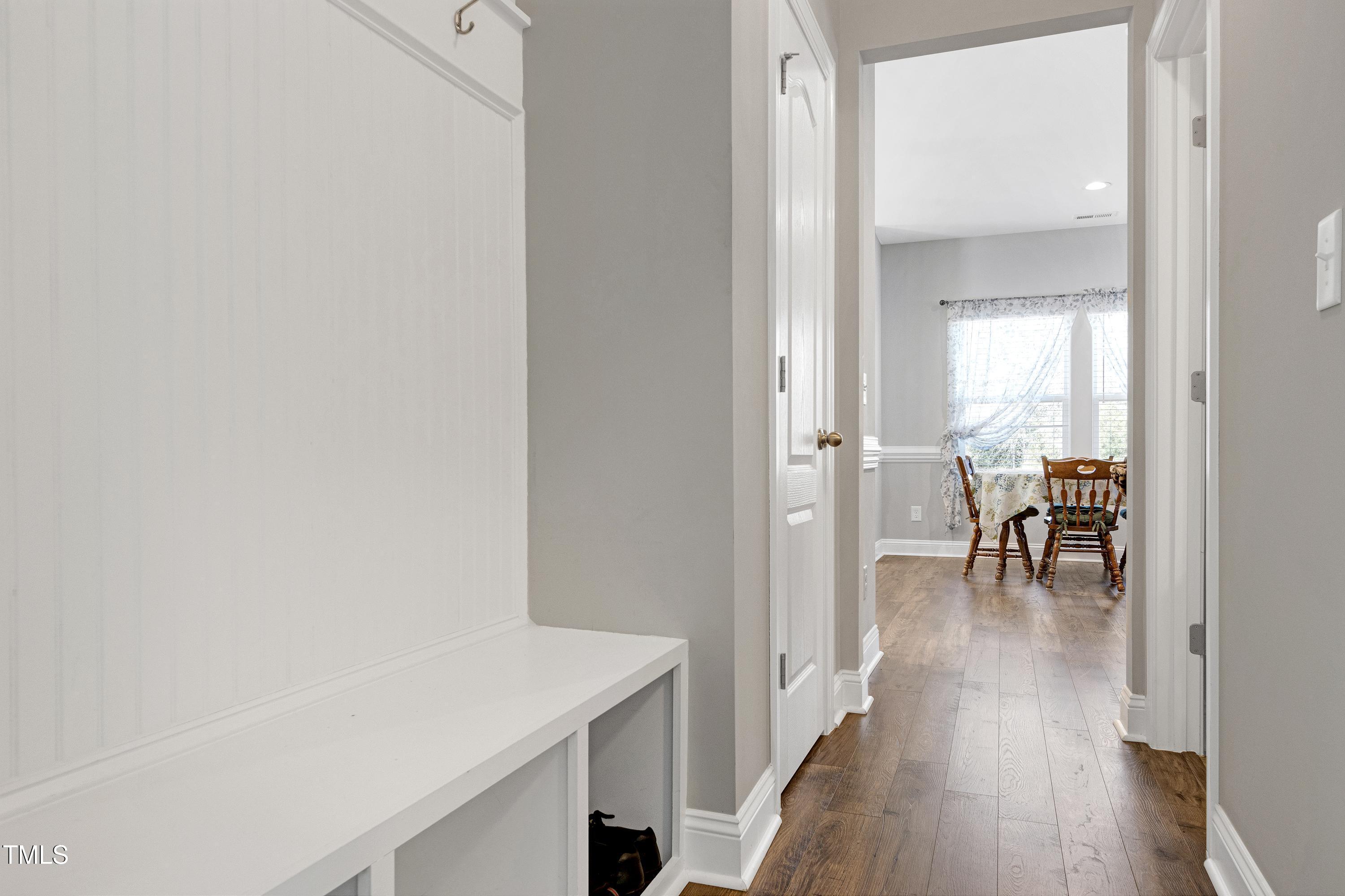 1613 Osprey Ridge Drive Willow Spring, NC 27592 - Photo 13 of 37 a view of a hallway with wooden floor table and chairs