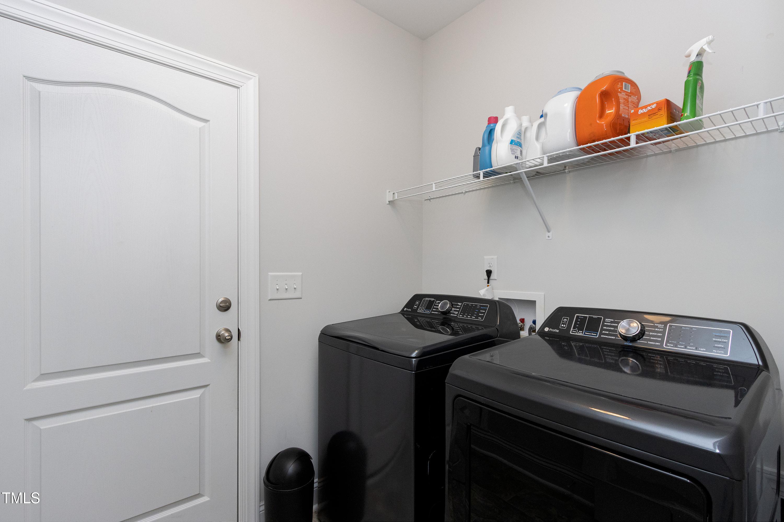 1613 Osprey Ridge Drive Willow Spring, NC 27592 - Photo 14 of 37 a view of storage and utility room with washer and dryer