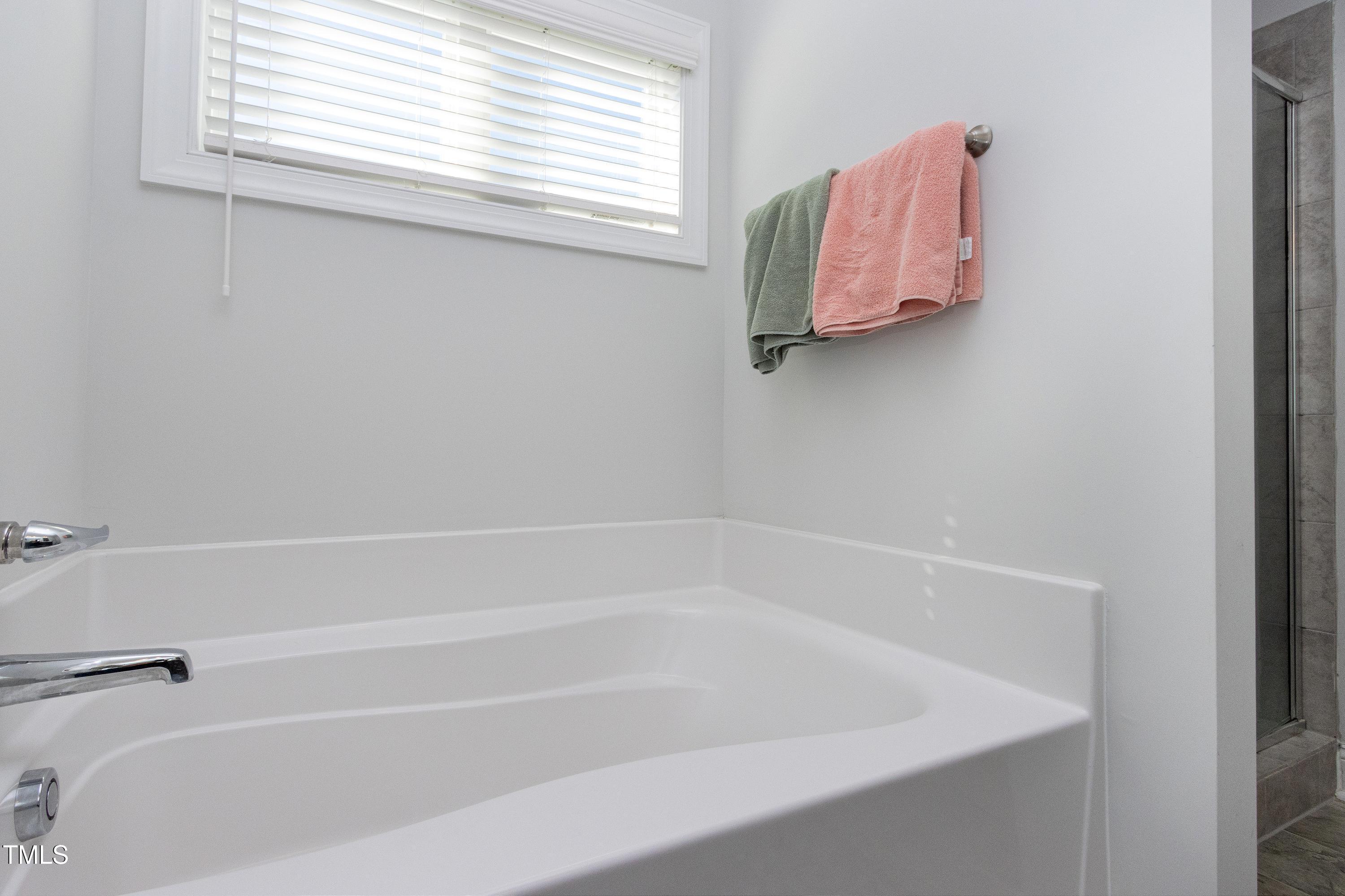 1613 Osprey Ridge Drive Willow Spring, NC 27592 - Photo 18 of 37 a close up of a bathtub in a bathroom