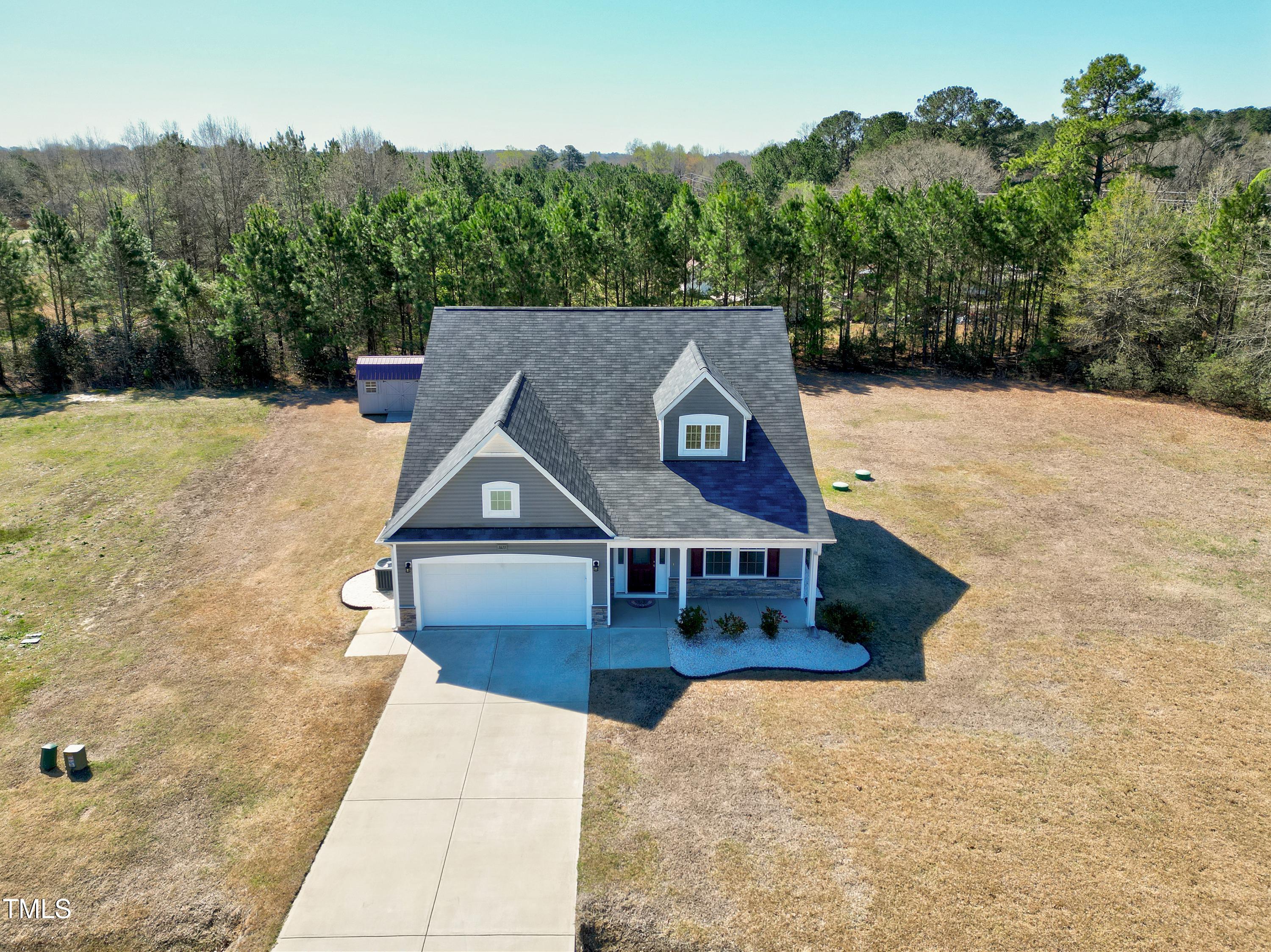 1613 Osprey Ridge Drive Willow Spring, NC 27592 - Photo 2 of 37 a front view of a house with a yard