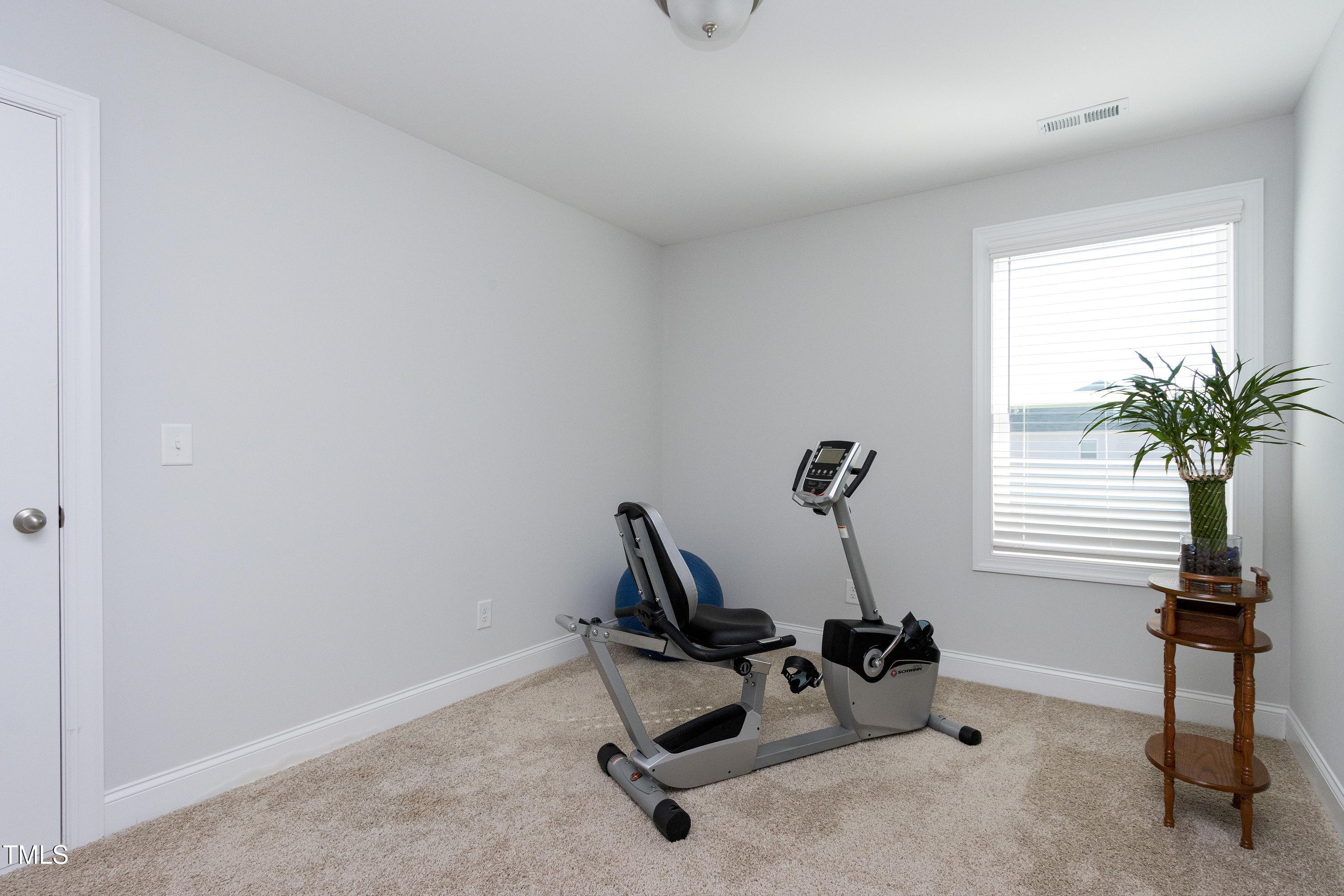 1613 Osprey Ridge Drive Willow Spring, NC 27592 - Photo 24 of 37 a view of a room with gym equipment