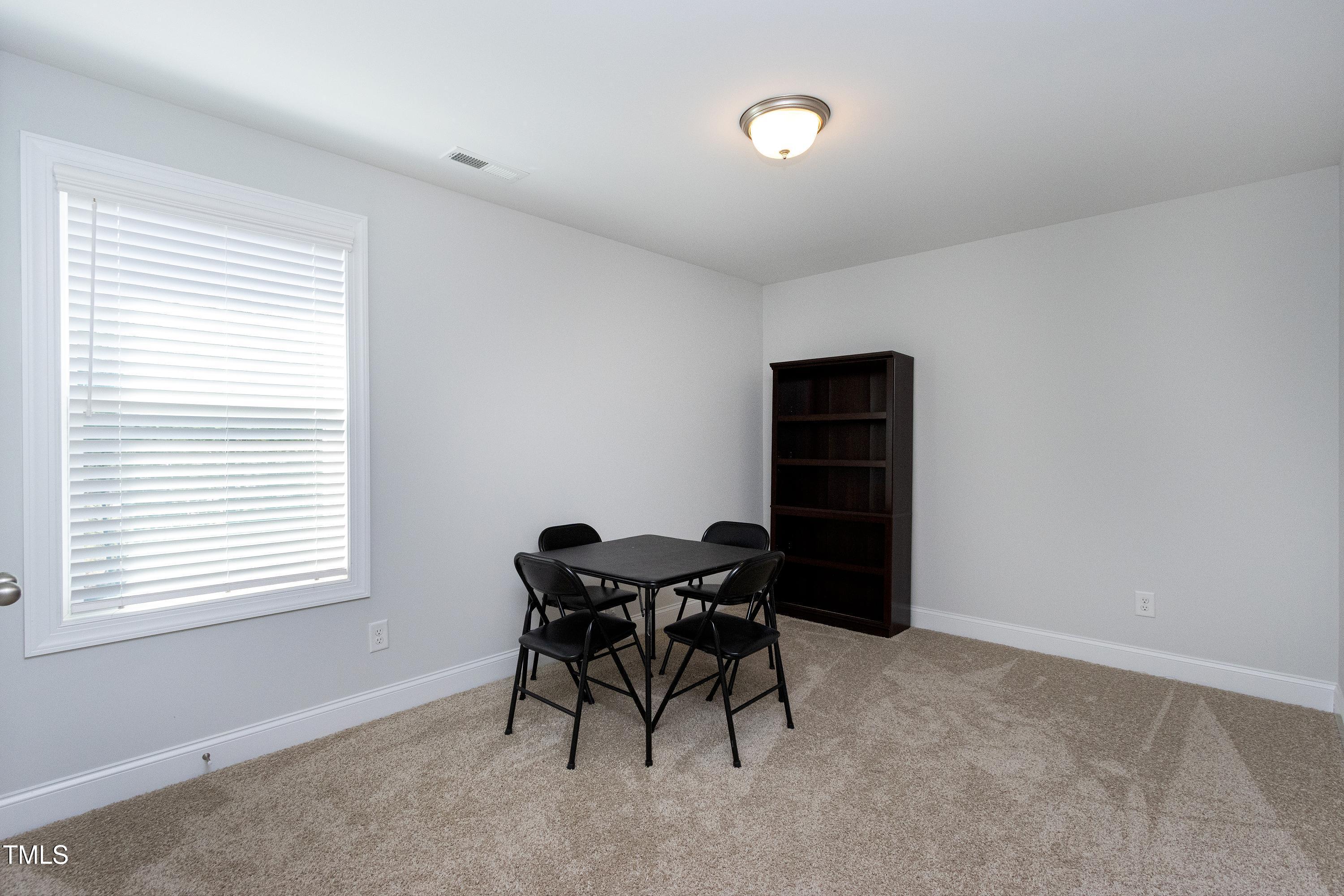 1613 Osprey Ridge Drive Willow Spring, NC 27592 - Photo 27 of 37 a view of a workspace with furniture and a window