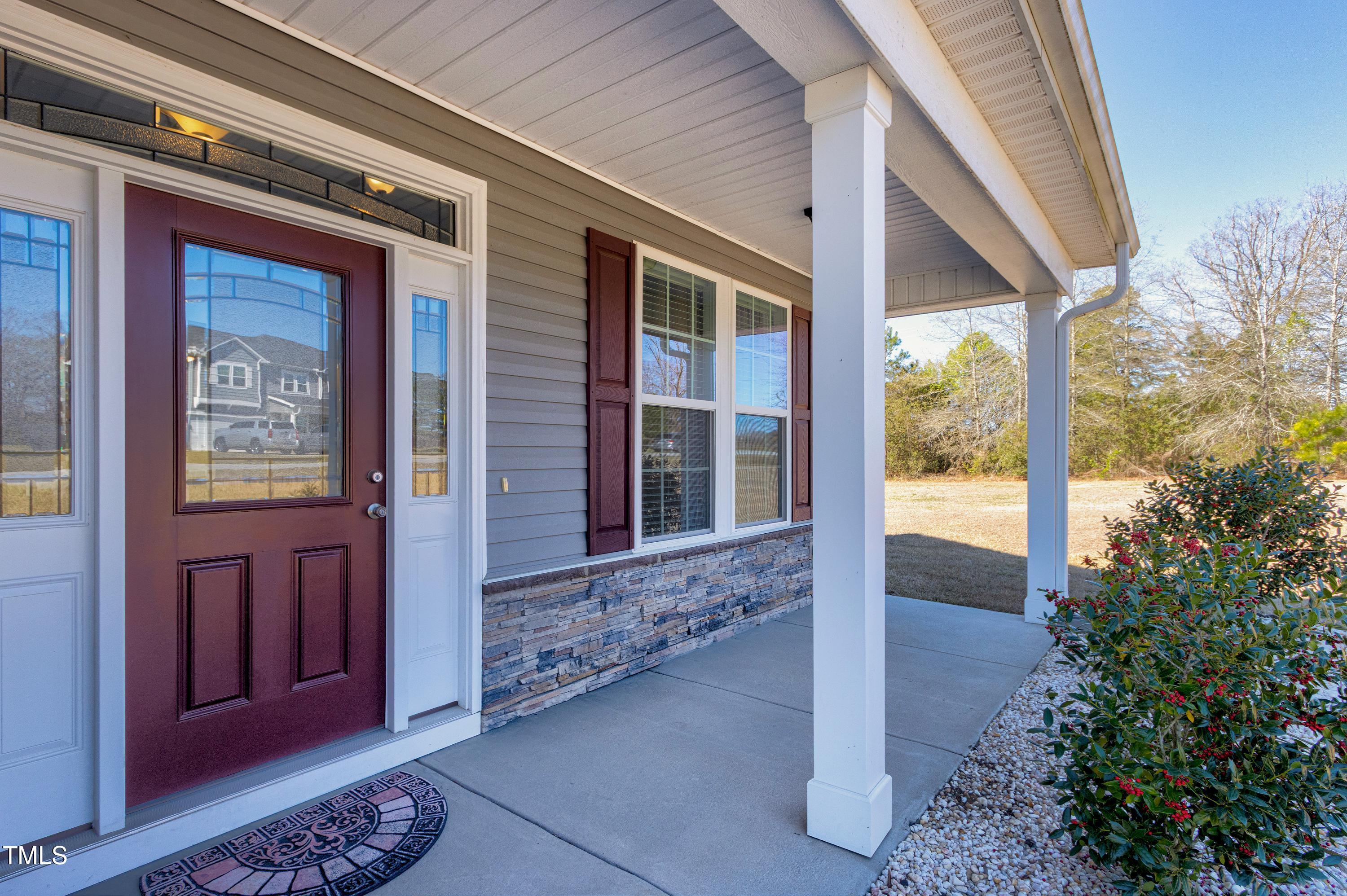1613 Osprey Ridge Drive Willow Spring, NC 27592 - Photo 4 of 37 a front view of a house with a porch