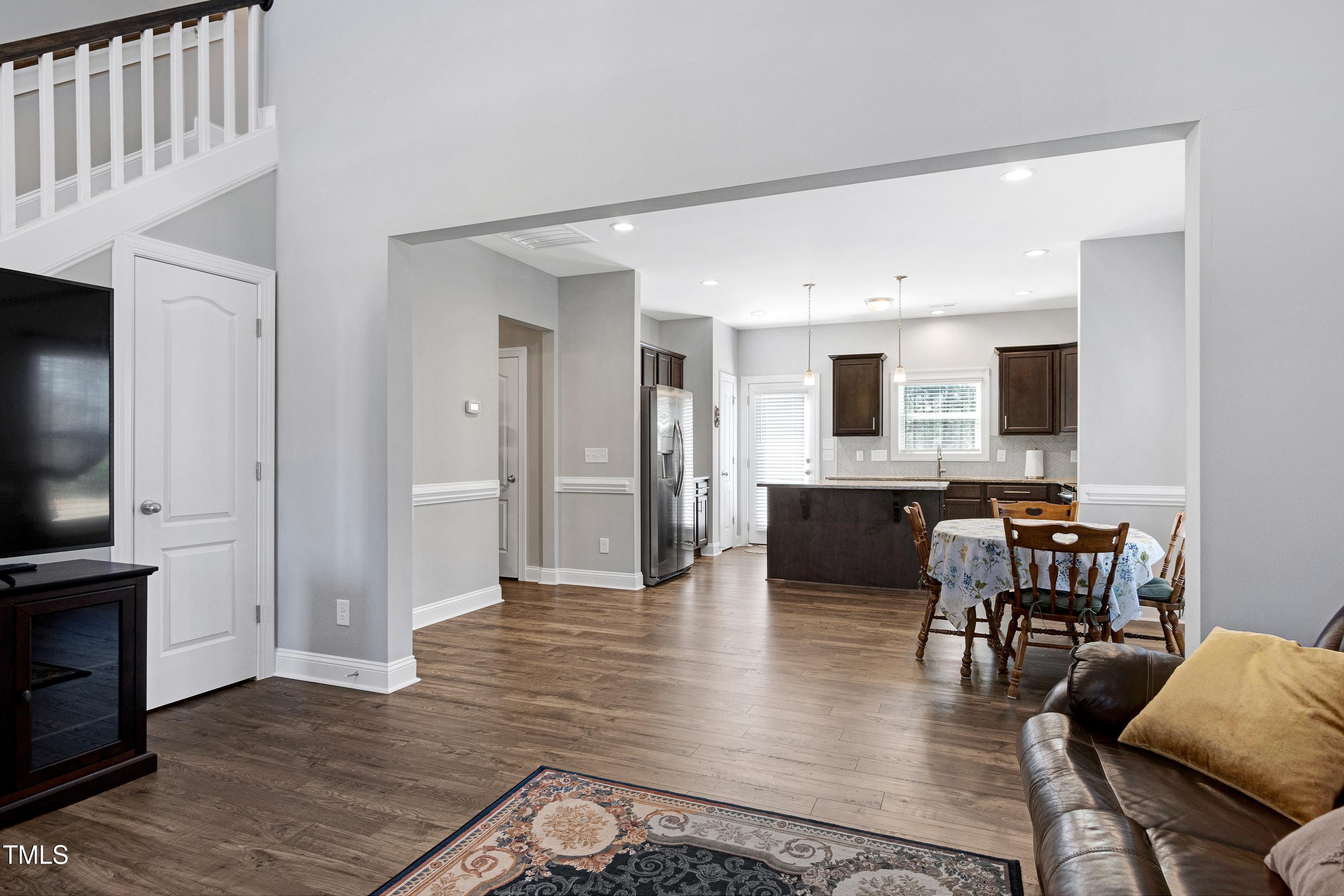 1613 Osprey Ridge Drive Willow Spring, NC 27592 - Photo 7 of 37 a view of a living room kitchen and a wooden floor