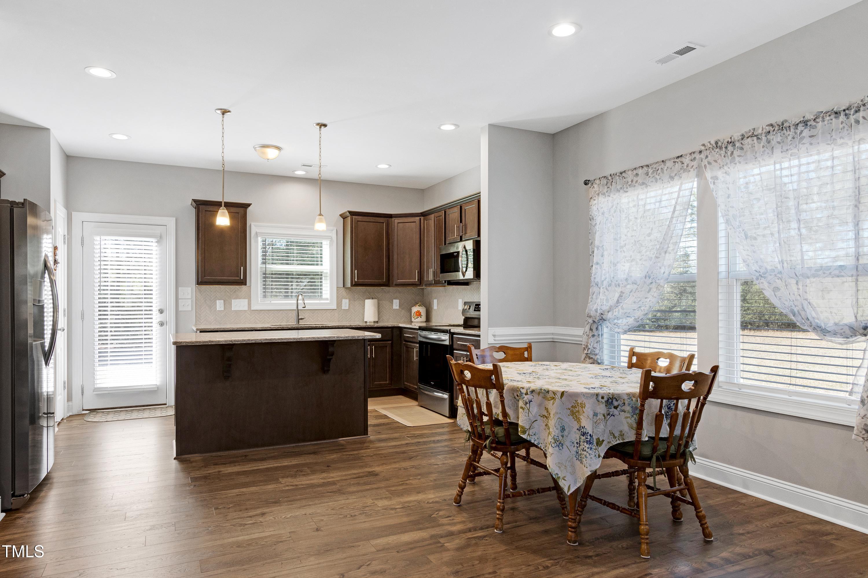 1613 Osprey Ridge Drive Willow Spring, NC 27592 - Photo 8 of 37 a view of a dining room with furniture window and wooden floor