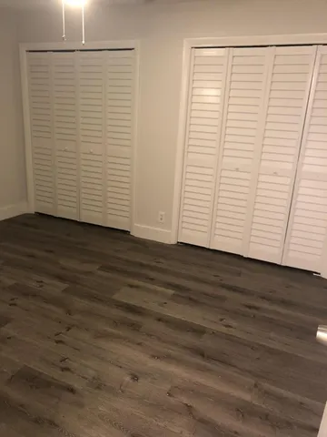 an empty room with wooden floor