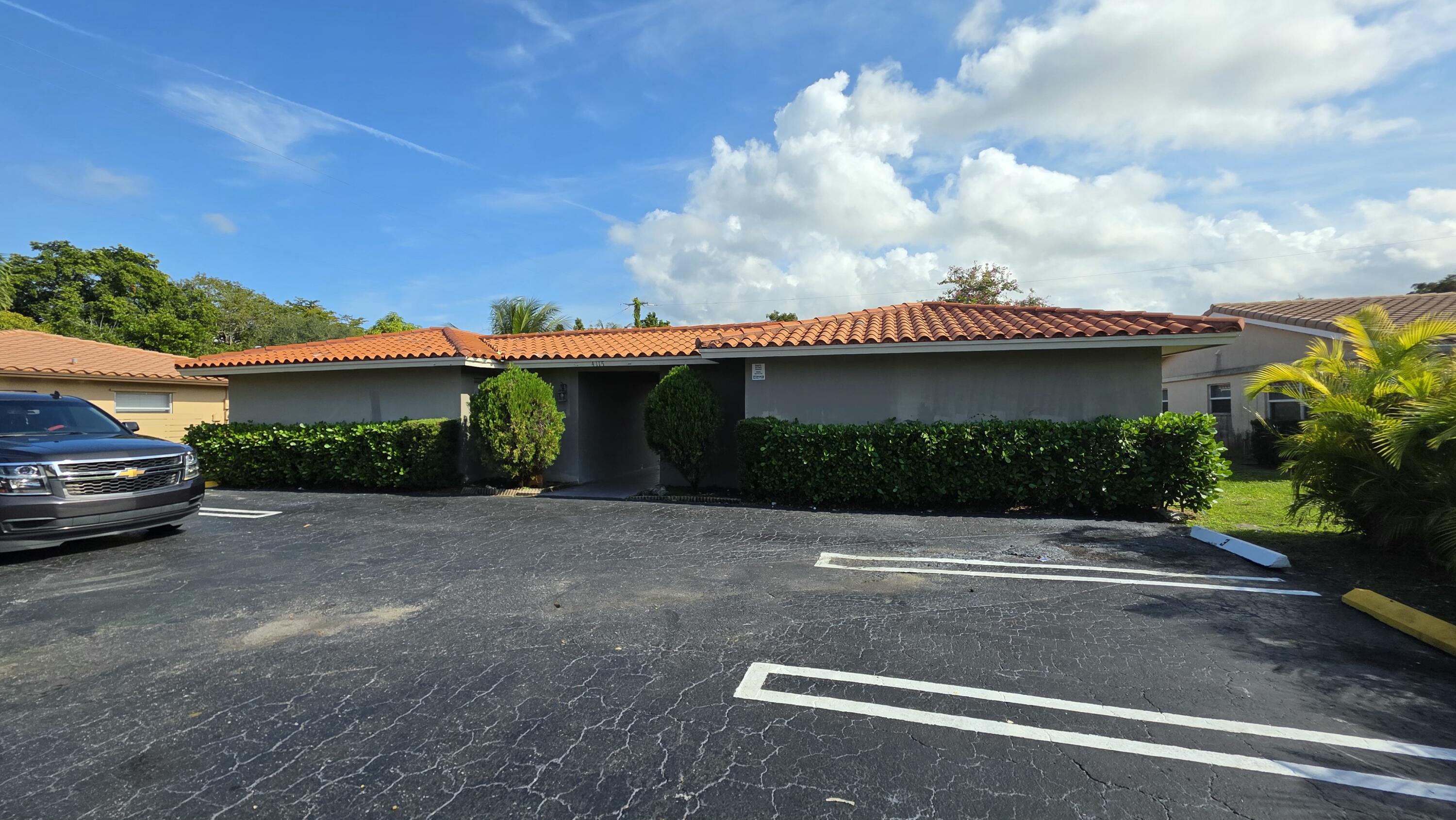4115 Riverside Drive, Unit 15 Coral Springs, FL 33065 - Photo 32 of 33 a view of a house with a yard
