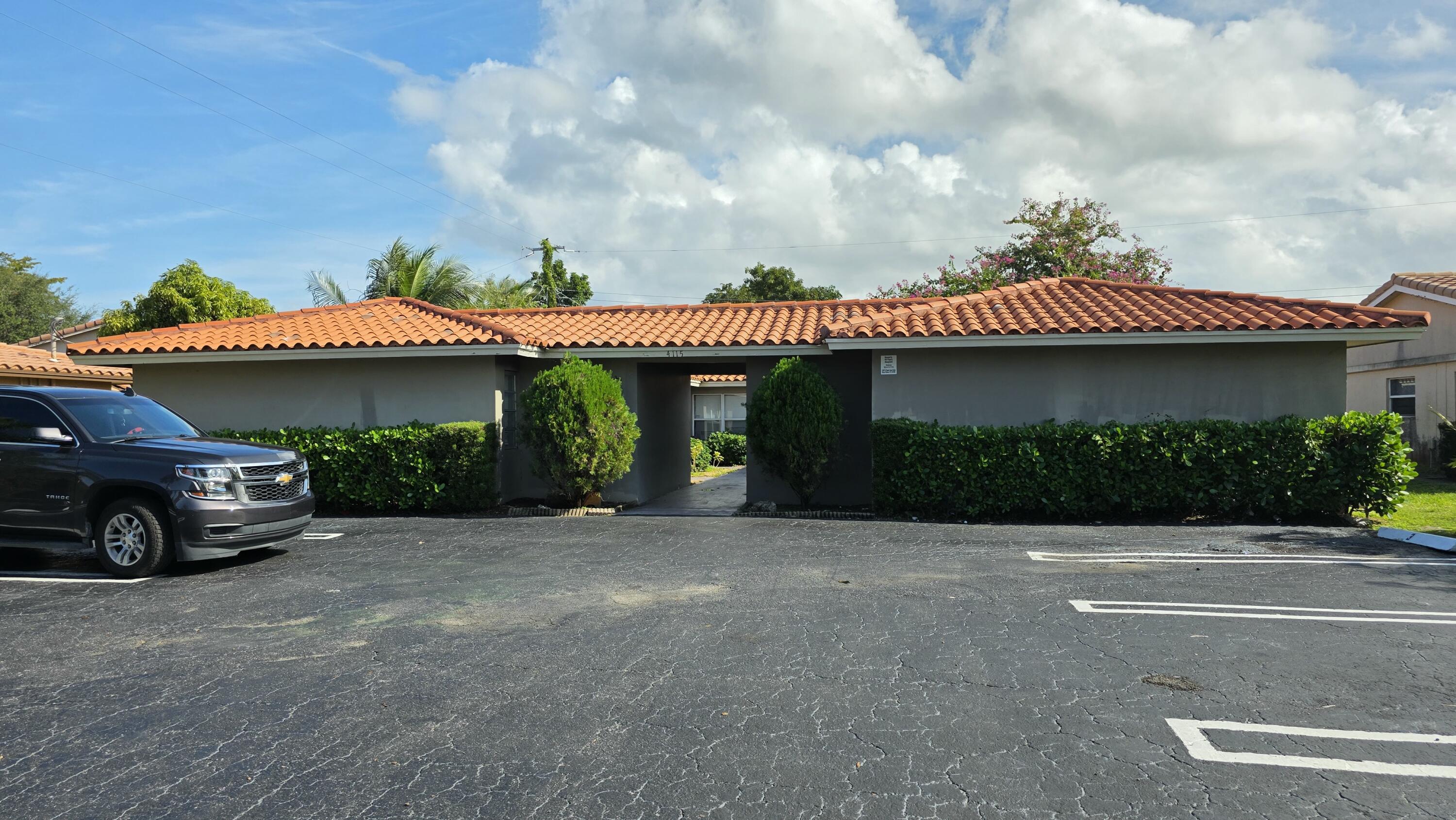 4115 Riverside Drive, Unit 15 Coral Springs, FL 33065 - Photo 33 of 33 a front view of a house with a garden