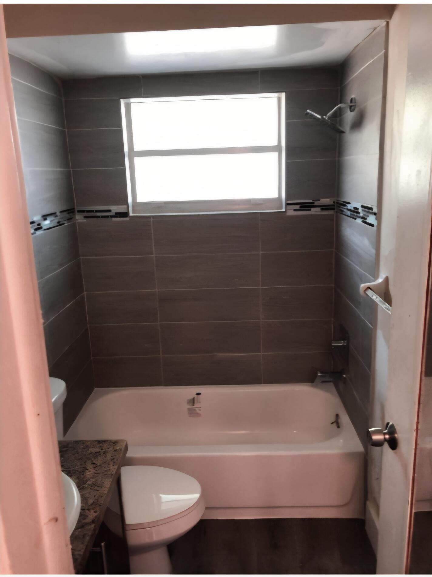 4115 Riverside Drive, Unit 15 Coral Springs, FL 33065 - Photo 6 of 33 a bathroom with a bathtub and shower