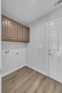 an empty room with window and ceiling fan